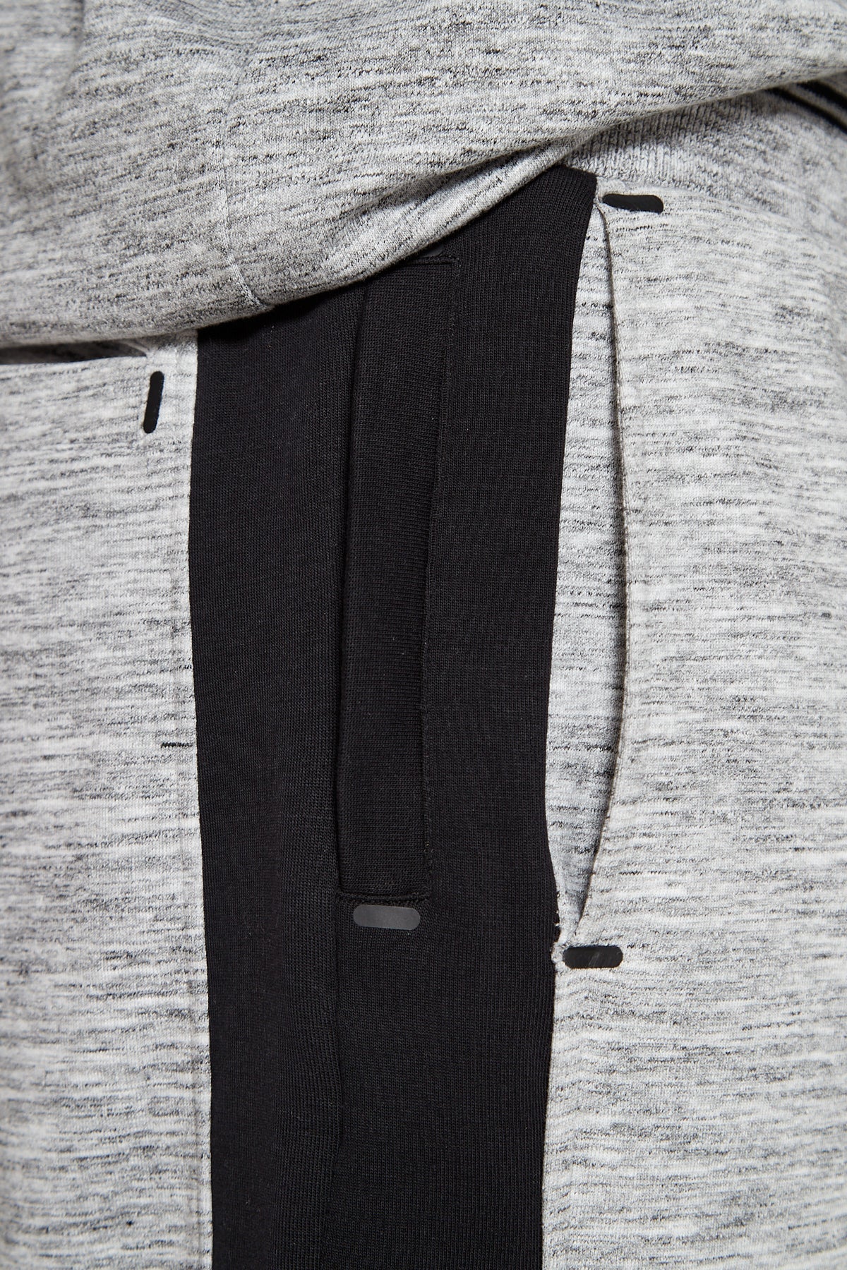 A side angle and close up shot of Original Creator Granite Grey zip pocket shorts with four pockets. The shorts feature a color combination of Grey and Black