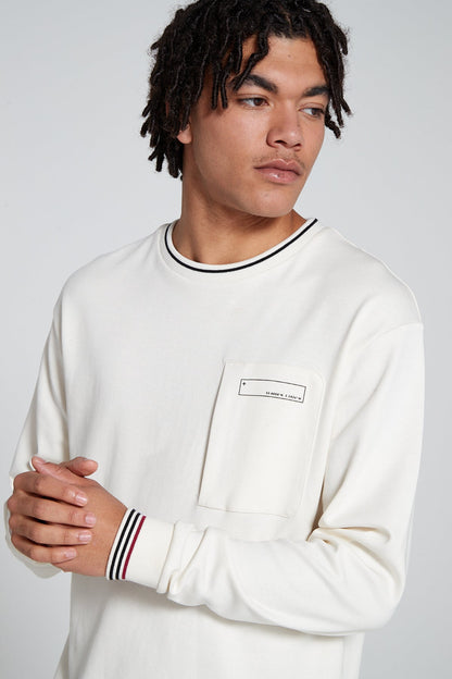 Model showing off front face of Original creator Zip Pocket Long Sleeve Off white T shirt looking away