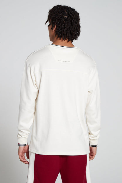 Model showing behind view wearing Original Creator Zip Pocket Long Sleeve Off white T shirt with very low branding at the back and features water repellent technology Minimalistic branding