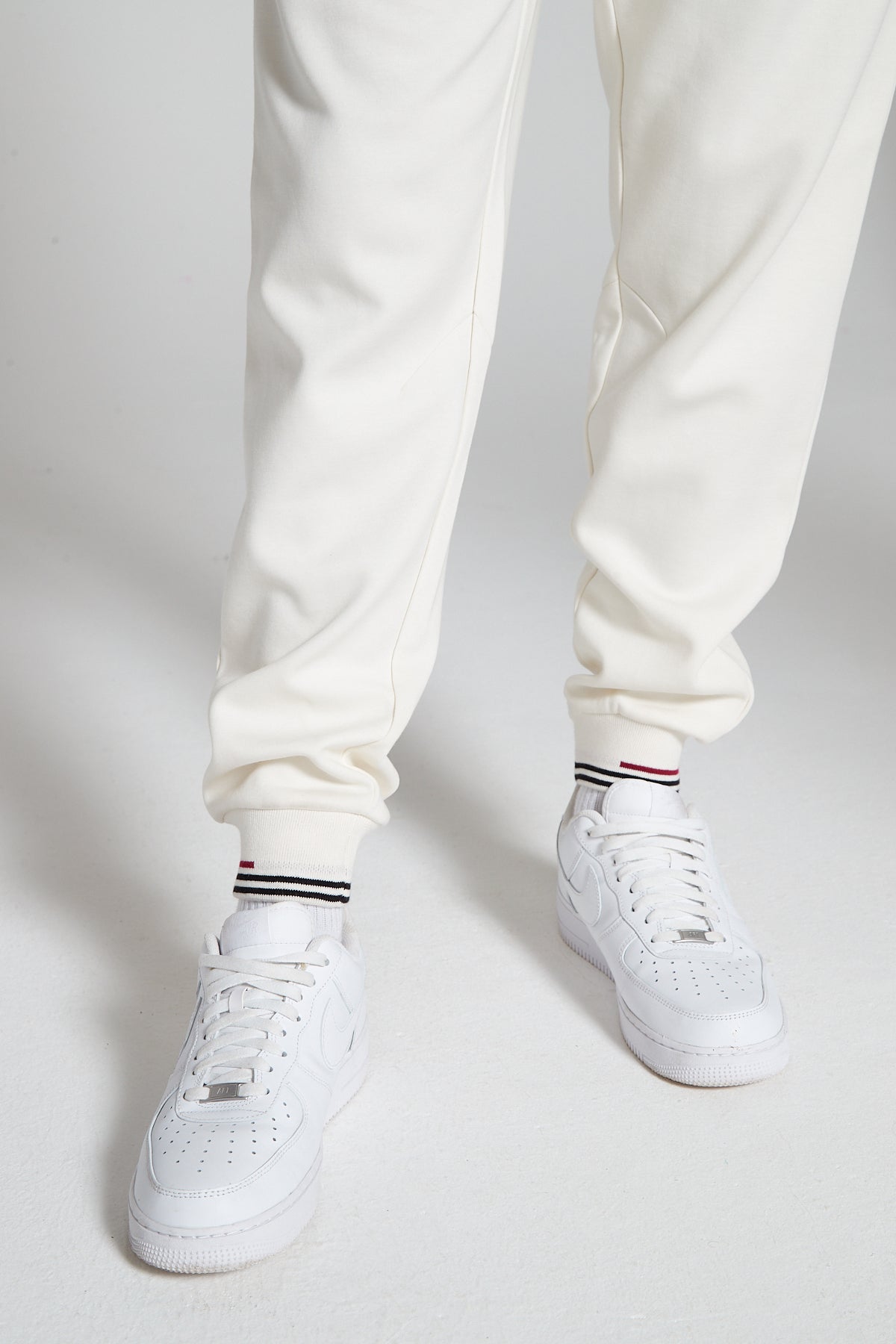 A close up shot of Original Creator Off White Classic Joggers showing the black and red lining on ankles. 