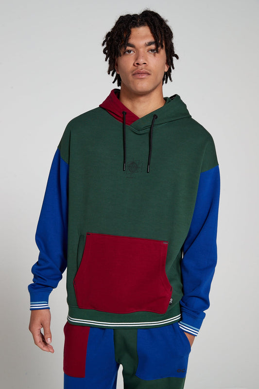 Model is wearing an Original Creator oversized Classic Multicolour Hoodie looking Straight ahead. Showing off cool color combination and a globe print on center chest.