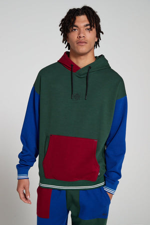 Model is wearing an Original Creator oversized Classic Multicolour Hoodie looking Straight ahead. Showing off cool color combination and a globe print on center chest.