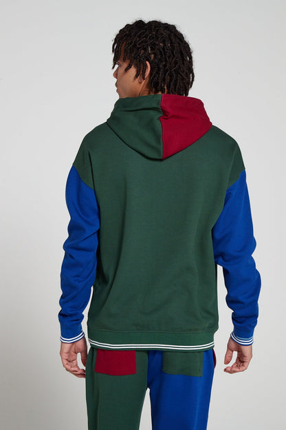 Model showing behind view wearing Original Creator oversized Classic Multicolour Hoodie with no branding at the back and featuring water repellent technology and classic line pattern on the sleeves